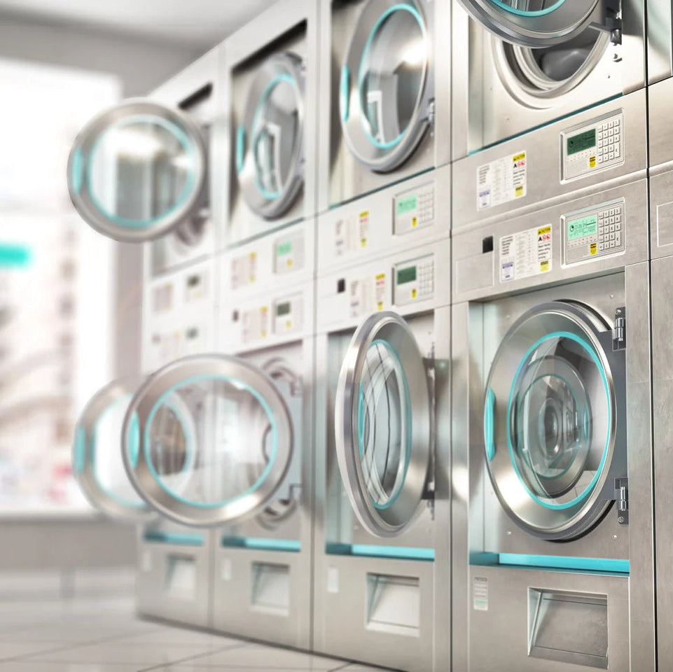 Row of industrial washing machines in a laundry facility